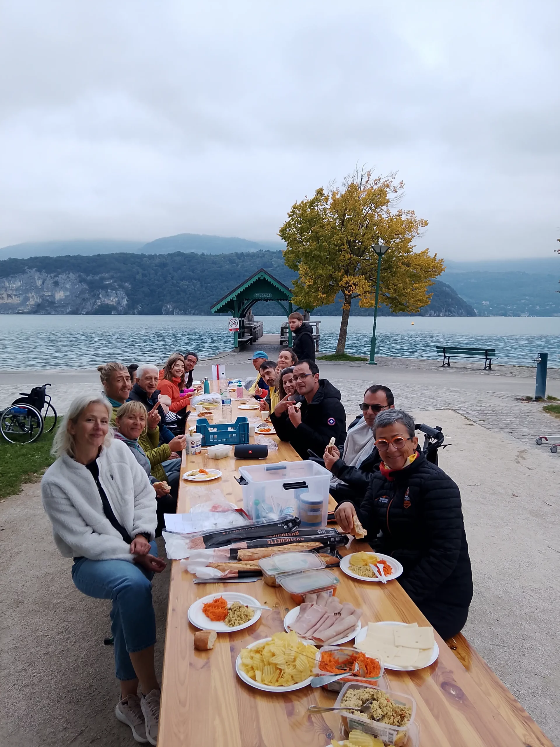les participants de la Maisonnée du Lac avec les bénévoles d'Handi Lac & Montagnes pendant la pause casse-croute